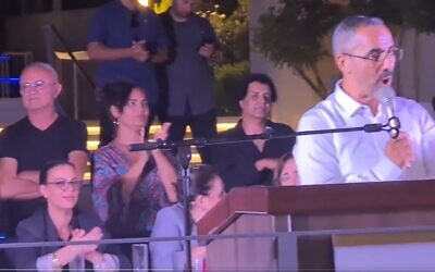 Herzliya city council candidate Rafi Chaim-Kedoshim speaks at a campaign event in the city as ministers, including Galit Distel Atbaryan (left) look on. (Screenshot used in accordance with clause 27a of the copyright law)