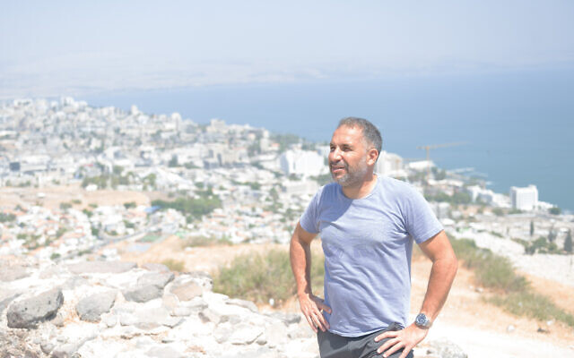 Ron Cobi, a former mayor of Tiberias and a candidate for the job, stands atop a hill overlooking his city in Israel on August 22, 2023. (Canaan Lidor/Times of Israel)