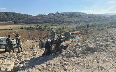 Police stand by an overturned all-terrain vehicle after chasing two suspects they believe were planning a hit on a mob figure in Shfaram, September 10, 2023 (Israel Police)
