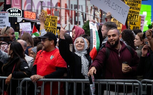 Pro-Palestinian demonstrators gesture toward Israelis during a protest in New York City, October 8, 2023. (Luke Tress/Times of Israel)