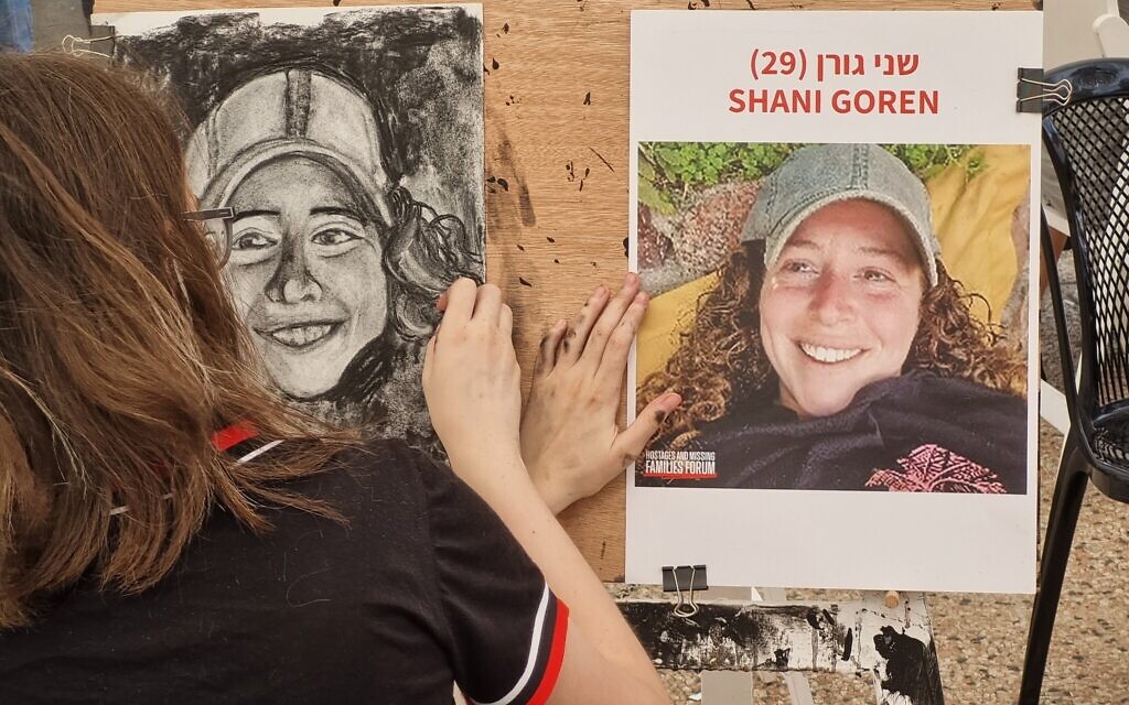 An artist paints a portrait of an Israeli hostage held by Hamas terrorists as part of the This is Us project at the Tel Aviv Museum of Art, October 26, 2023. (Bernard Dichek)