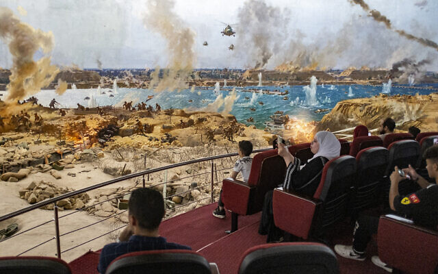 People attend a presentation of a recreated war scene while visiting the "6th of October War Panorama" museum and memorial of the 1973 Arab-Israeli War in Cairo, Egypt, on October 1, 2023. (Khaled DESOUKI/AFP)