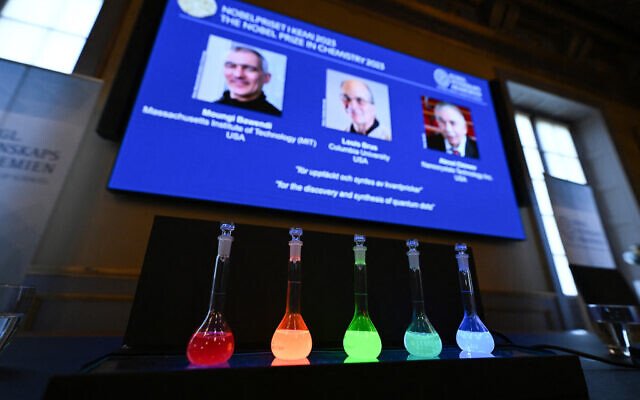 Laboratory flasks are used for explanation during the announcement of the winners of the 2023 Nobel Prize in chemistry at Royal Swedish Academy of Sciences in Stockholm on October 4, 2023. (Jonathan Nackstrand/AFP)