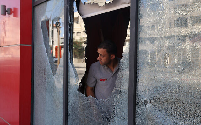 A Palestinian man inspects the damage to a store in the village of Huwara in the  West Bank on October 6, 2023, after an overnight attack by Israeli settlers. (Jaafar ASHTIYEH / AFP)