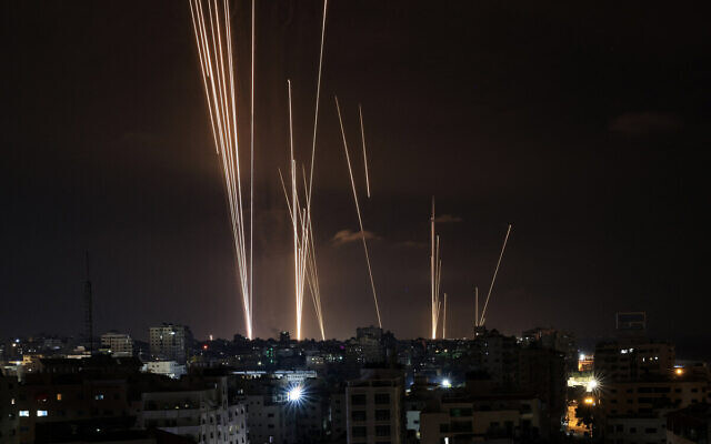 A salvo of rockets is fired by Palestinian terrorists from the Gaza City toward Israel on October 7, 2023. (MAHMUD HAMS / AFP)