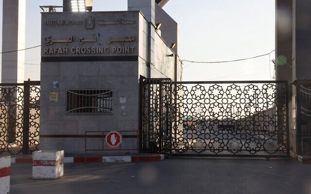 A picture taken on October 10, 2023, shows the closed gates of the Rafah border crossing with Egypt. (Photo by SAID KHATIB / AFP)