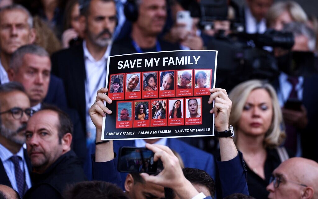 People hold placards reading "Save My Family' during a tribute to the victims of the Hamas-organized massacre in Israel, at the European Parliament in Brussels, on October 11, 2023. (Kenzo TRIBOUILLARD / AFP)
