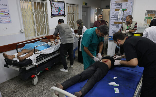 Palestinians are treated at a hospital in the city of Rafah, in the southern Gaza Strip on October 12, 2023. (Said Khatib/AFP)