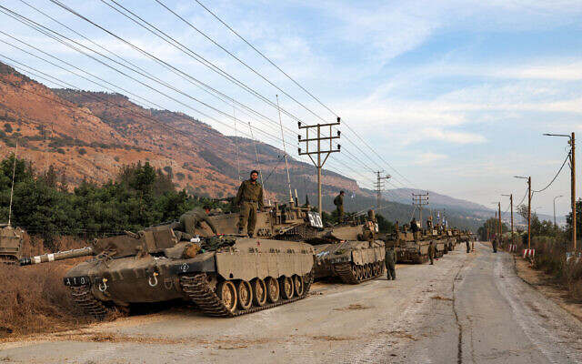 A column of Israeli Merkava battle tanks is amassed in the upper Galilee in northern Israel near the border with Lebanon on October 11, 2023. (Jalaa MAREY / AFP)