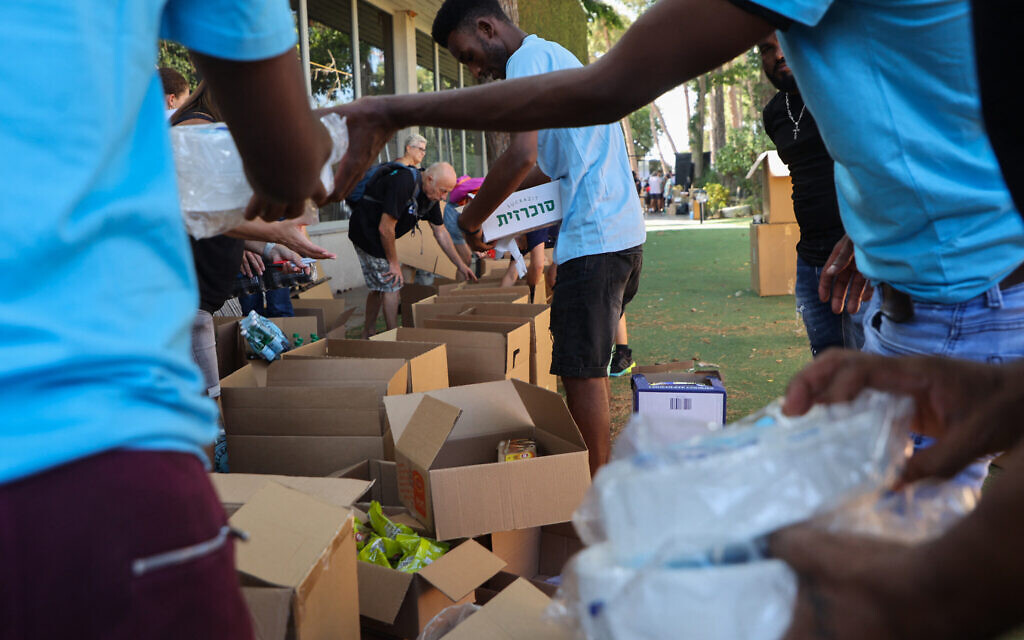 Volunteers prepare aid packages and supplies for Israeli soldiers and evacuated residents in Tel Aviv on October 12, 2023. (Gil Cohen-Magen/AFP)