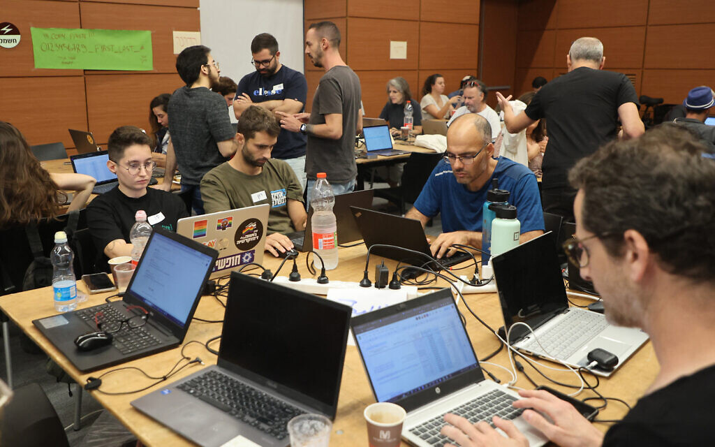 Volunteers take part in a taskforce in Tel Aviv on October 12, 2023, to identify missing persons in the aftermath of a surprise attack by Palestinian Hamas terrorists on communities in southern Israel. (Gil Cohen-Magen/AFP)