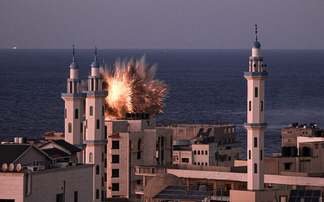 A fireball erupts from an Israeli airstrike in Gaza City on October 12, 2023. (Photo by MAHMUD HAMS / AFP)