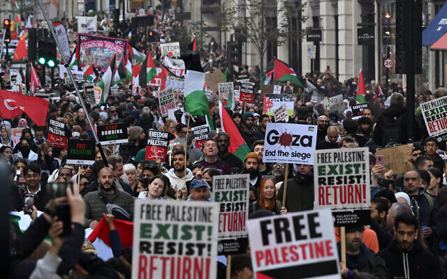 People walk down Regent Street as they take part in a 'March For Palestine' in London on October 14, 2023. (Justin Tallis/AFP)