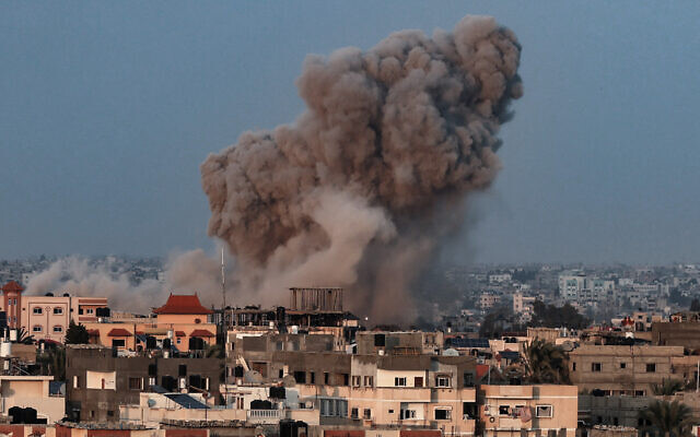 Smoke plumes rising above buildings during an Israeli strike on Rafah in the southern Gaza Strip on October 14, 2023. (Said Khatib/AFP)