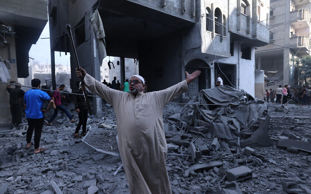 A Palestinian reacts amidst the rubble of a building after an Israeli airstrike on the Rafah refugee camp, in the southern Gaza Strip on October 17, 2023 (MOHAMMED ABED / AFP)