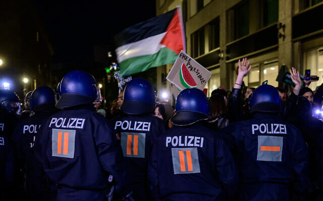 German riot police officers push back Pro-Palestinian demonstrators as they protest against the bombing in Gaza outside the Foreign Ministry in Berlin on October 18, 2023. (Photo by John MACDOUGALL / AFP)