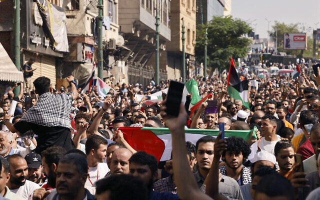 People take to the street during a protest supporting the Palestinian people following Friday Noon prayers outside the al-Azhar Mosque in Cairo on October 20, 2023, amid the ongoing battles between Israel and the Palestinian group Hamas. (Photo by Khaled DESOUKI / AFP)