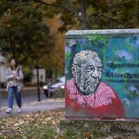 A mural portraying Polish-Israeli Holocaust historian and educator Alex Dancyg, who was taken hostage from Kibbutz Nir Oz on October 7, 2023, with the subtitle referring to him as 'Ambassador of Dialogue,' can be seen in Warsaw, Poland on October 19, 2023. (Wojtek Radwanski/AFP)