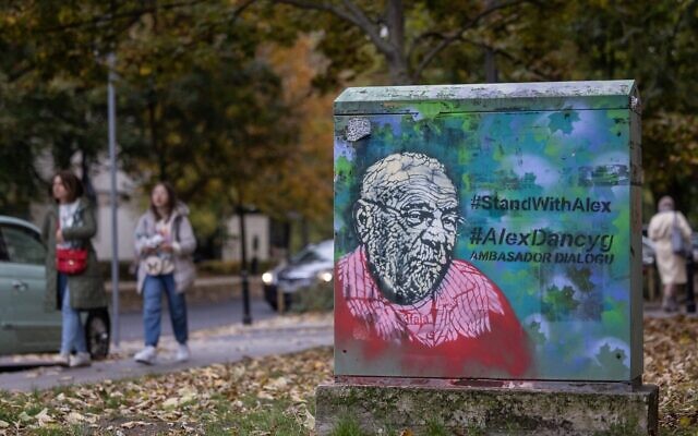 A mural portraying Polish-Israeli Holocaust historian and educator Alex Dancyg, who was taken hostage when Hamas terrorists stormed the Nir Oz kibbutz in Israel near the Gaza border on October 7, 2023, with the subtitle referring to him as 'Ambassador of Dialogue,' can be seen in Warsaw, Poland. (Wojtek Radwanski/AFP)