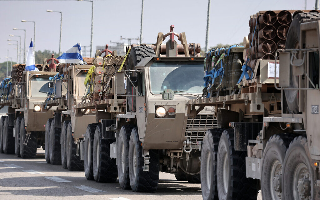A convoy of Israeli army trucks carrying mortar shells advances on a road near the southern city of Sderot, on October 23, 2023. (Thomas COEX / AFP)