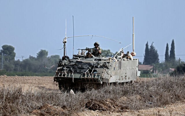 A Israeli army APC in a field near the southern Israeli city of Sderot, on October 23, 2023. (Photo by Thomas COEX / AFP)