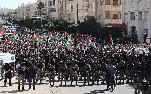 Demonstrators chant slogans near the Israeli Embassy in Amman on October 20, 2023. (Khalil Mazraawi/AFP)