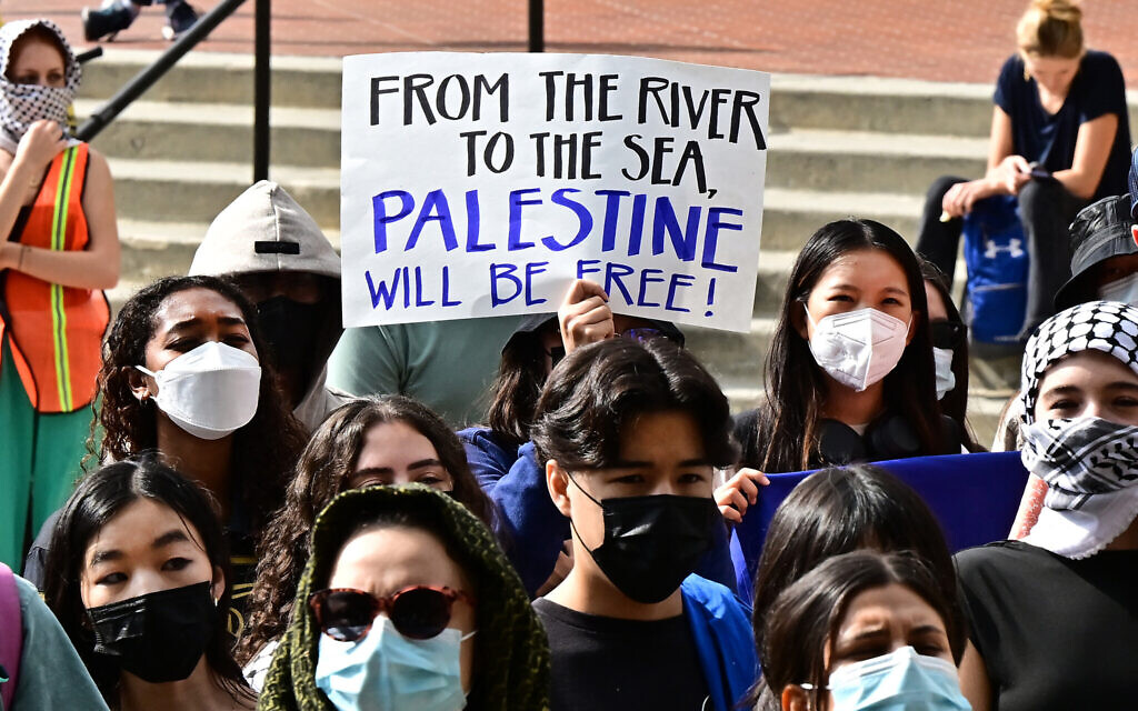 A participant holds a placard as students gather during a 'Walkout to fight Genocide and Free Palestine' at Bruin Plaza at UCLA (University of California, Los Angeles) in Los Angeles on October 25, 2023 (Frederic J. BROWN / AFP)