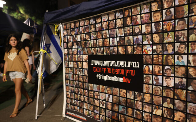 A poster shows Israelis seized by terrorists on October 7, at a press conference in Tel Aviv on October 30, 2023. (AHMAD GHARABLI / AFP)