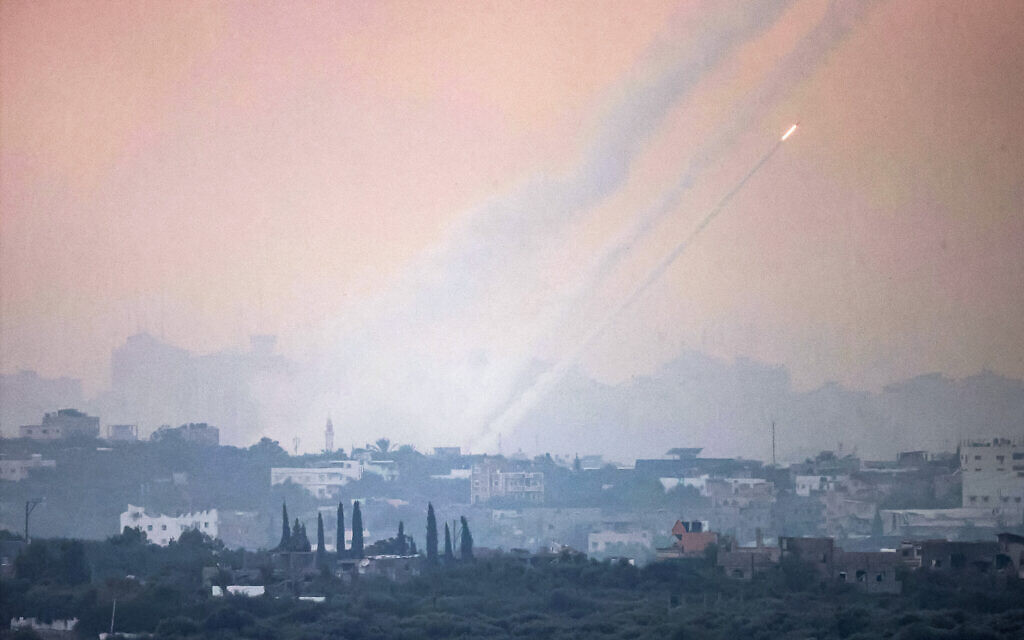 This picture taken on October 31, 2023 from a position along the border with the Gaza Strip in southern Israel shows a salvo of rockets being fired from inside the Gaza Strip towards Israel amid ongoing battles between Israeli forces and the Palestinian Hamas movement. (Photo by Menahem KAHANA / AFP)