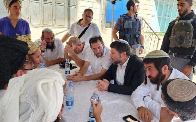 Finance Minister Bezalel Smotrich (seated with blazer) in the northern West Bank town of Huwara on October 6, 2023. (via Facebook; used in accordance with clause 27a of the copyright law)