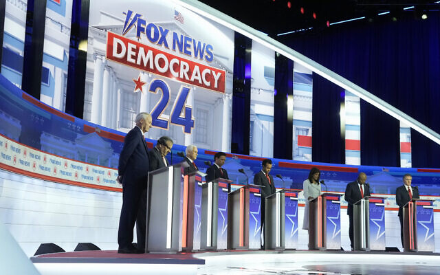 Republican US presidential candidates, from left, former Arkansas Governor Asa Hutchinson, former New Jersey Governor Chris Christie, former vice president Mike Pence, Florida Governor Ron DeSantis, businessman Vivek Ramaswamy, former UN Ambassador Nikki Haley, Senator Tim Scott and North Dakota Governor Doug Burgum stand on stage before a Republican presidential primary debate hosted by Fox News Channel, August 23, 2023, in Milwaukee. (AP Photo/Morry Gash)