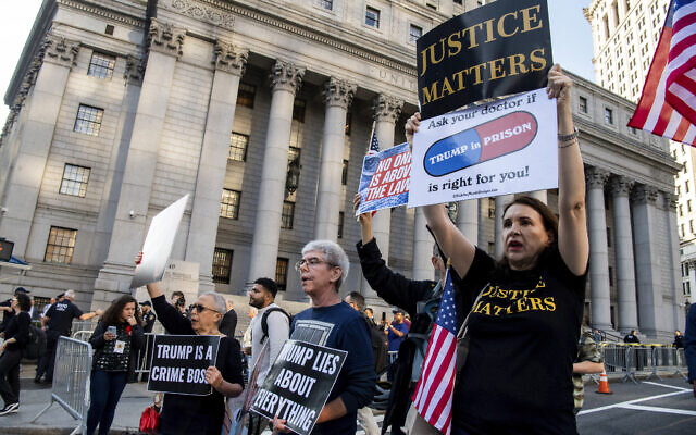 Protesters chant outside New York Supreme Court ahead of former President Donald Trump's civil business fraud trial on Monday, Oct. 2, 2023 in New York. (AP Photo/Brittainy Newman)