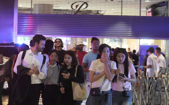 Visitors evacuate from a shopping mall in Bangkok, Thailand, October 3, 2023. (AP Photo/Sakchai Lalit)