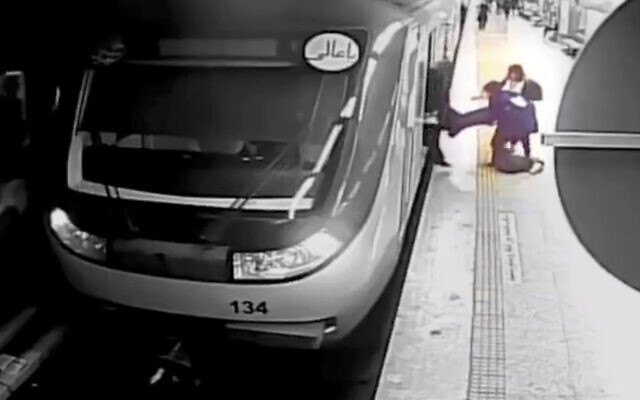 In this image from surveillance video aired by Iranian state television, women pull 16-year-old Armita Geravand from a train car on the Tehran Metro in Tehran, Iran, Sunday, Oct. 1, 2023. The mysterious injury suffered by Geravand not wearing a headscarf while boarding a Metro train in Iran's capital has reignited anger just after the one-year anniversary of the death of Mahsa Amini and the nationwide protests it sparked. (AP Photo/Iranian state television)
