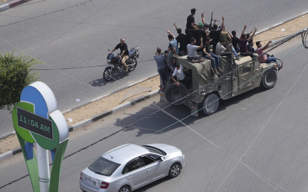 Palestinians drive a captured Israeli military vehicle in Gaza City on Oct. 7, 2023. (AP Photo/Hatem Moussa)