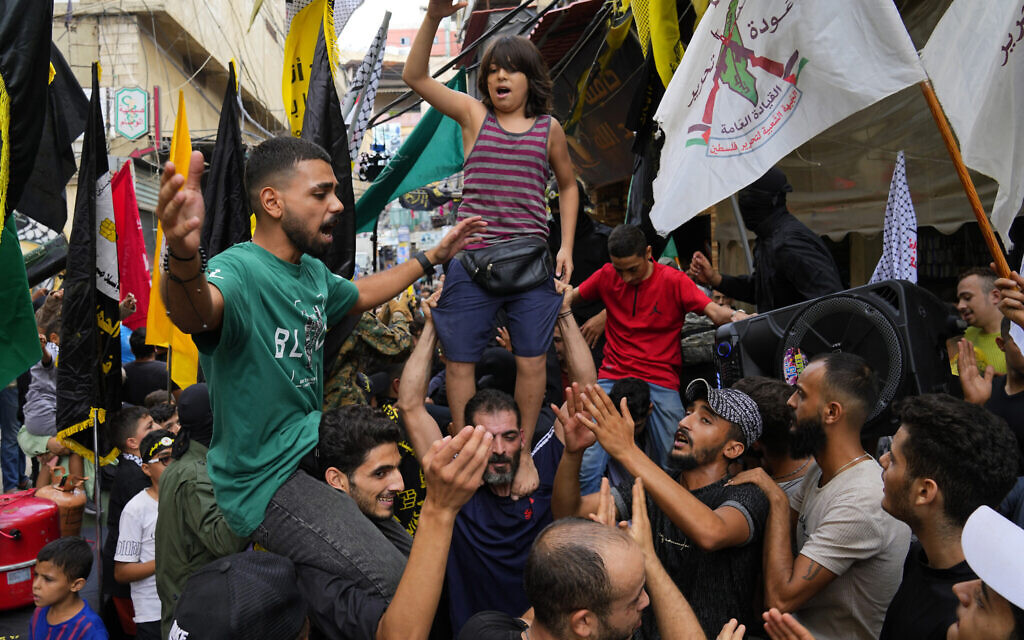 People dance in celebration of the attacks that the Hamas terror group carried out against Israel, at Bourj al-Barajneh Palestinian refugee camp, in Beirut, Lebanon, October 7, 2023. (AP Photo/Bilal Hussein)