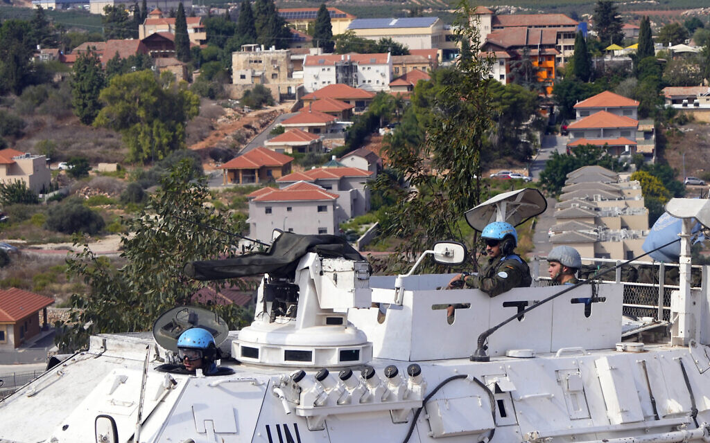 UN peacekeepers patrol on the Lebanese side of the Lebanese-Israeli border in the southern village of Kfar Kila, with the northern Israeli town of Metulla in the background, Lebanon, October 9, 2023. (AP Photo/Hassan Ammar)