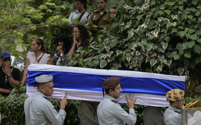 Israeli soldiers carry the flag-covered coffin of Col. Roi Levy during his funeral at the Mount Herzl cemetery in Jerusalem on Monday, Oct. 9, 2023. . (AP Photo/Maya Alleruzzo)