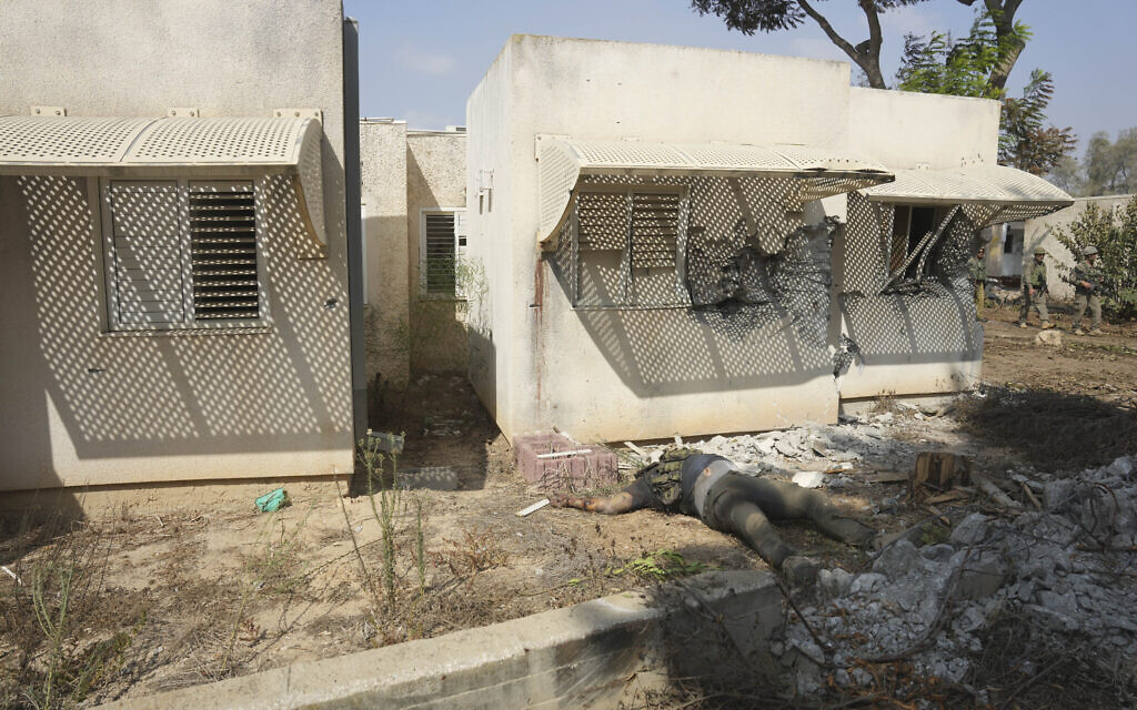 The body of a Hamas terrorist lays in Kibbutz Kfar Aza on Tuesday, Oct. 10, 2023. Hamas gunmen overran Kfar Aza on Saturday, where dozens of Israelis were killed and taken captive. (AP Photo/Erik Marmor)