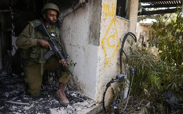 An Israeli soldier takes a position in Kibbutz Kfar Aza on Tuesday, Oct. 10, 2023. (AP Photo/Ohad Zwigenberg)