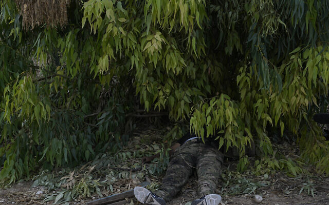 The body of a Hamas terrorist lies on the ground in kibbutz Kfar Aza on Tuesday, Oct. 10, 2023. (AP Photo/Ohad Zwigenberg)