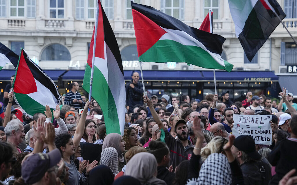 People wave Palestinian flags during a pro-Palestinian rally in Marseille, France, October 10, 2023. (AP Photo/Pavel Golovkin)