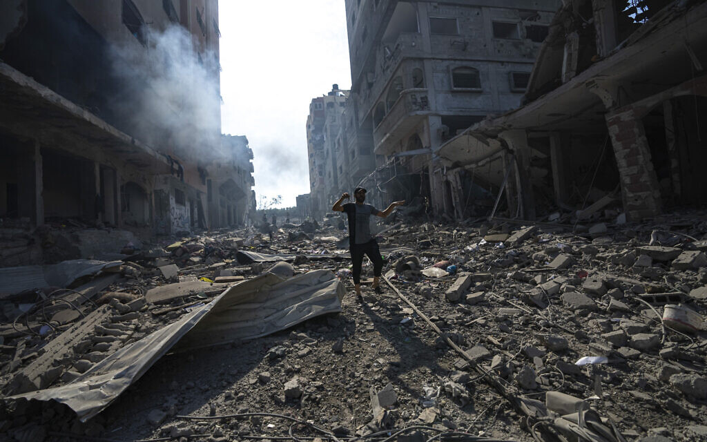 A Palestinian walks through the destruction by Israeli bombing in Gaza City on Wednesday, Oct. 11, 2023. (AP/Fatima Shbair)