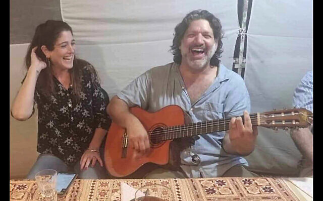 This image provided by Eran Shani shows Shlomi Mathias playing the guitar as his wife, Debbie ‘Shahar’ Mathias, laughs and sings next to him at her 50th birthday party in Lehavim, Israel, on October 1, 2023, days before they were killed in a Hamas terror attack as they protected their son. (Eran Shani via AP)