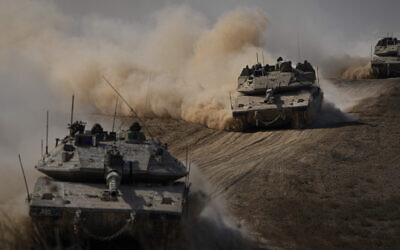 Israeli tanks head toward the Gaza Strip border in southern Israel on October 13, 2023. (AP Photo/Ariel Schalit)