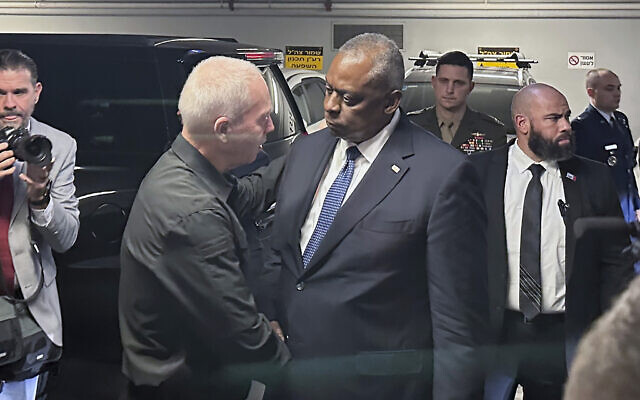 US Defense Secretary Lloyd Austin, right, is greeted by Defense Minister Yoav Gallant in Tel Aviv, Oct. 13, 2023. (AP Photos/Lolita Baldor)