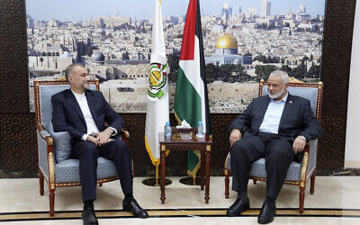In this picture released by the Iranian Foreign Ministry, Iran's Foreign Minister Hossein Amirabdollahian, left, meets with Ismail Haniyeh, a leader from the Palestinian terror group Hamas, in Doha, Qatar, October 14, 2023. (Iranian Foreign Ministry via AP)