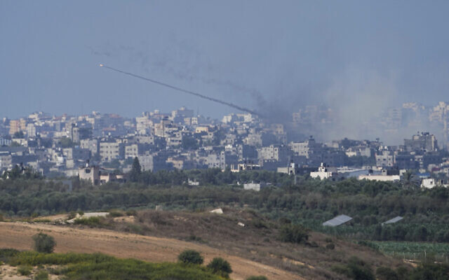 Rockets are fired toward Israel from the Gaza Strip, as seen from southern Israel, Oct. 15, 2023 (AP Photo/Ariel Schalit)