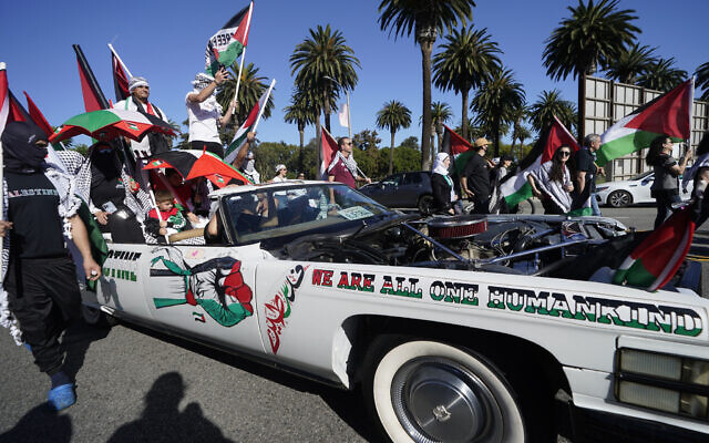 Demonstrators ride a vehicle during a pro-Palestinian protest Saturday, Oct. 14, 2023, in Los Angeles. (AP Photo/Damian Dovarganes)