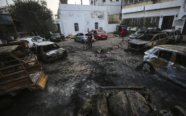 Palestinians check the site of an explosion at al-Ahli hospital, in Gaza City, Oct. 18, 2023. (AP/Abed Khaled)